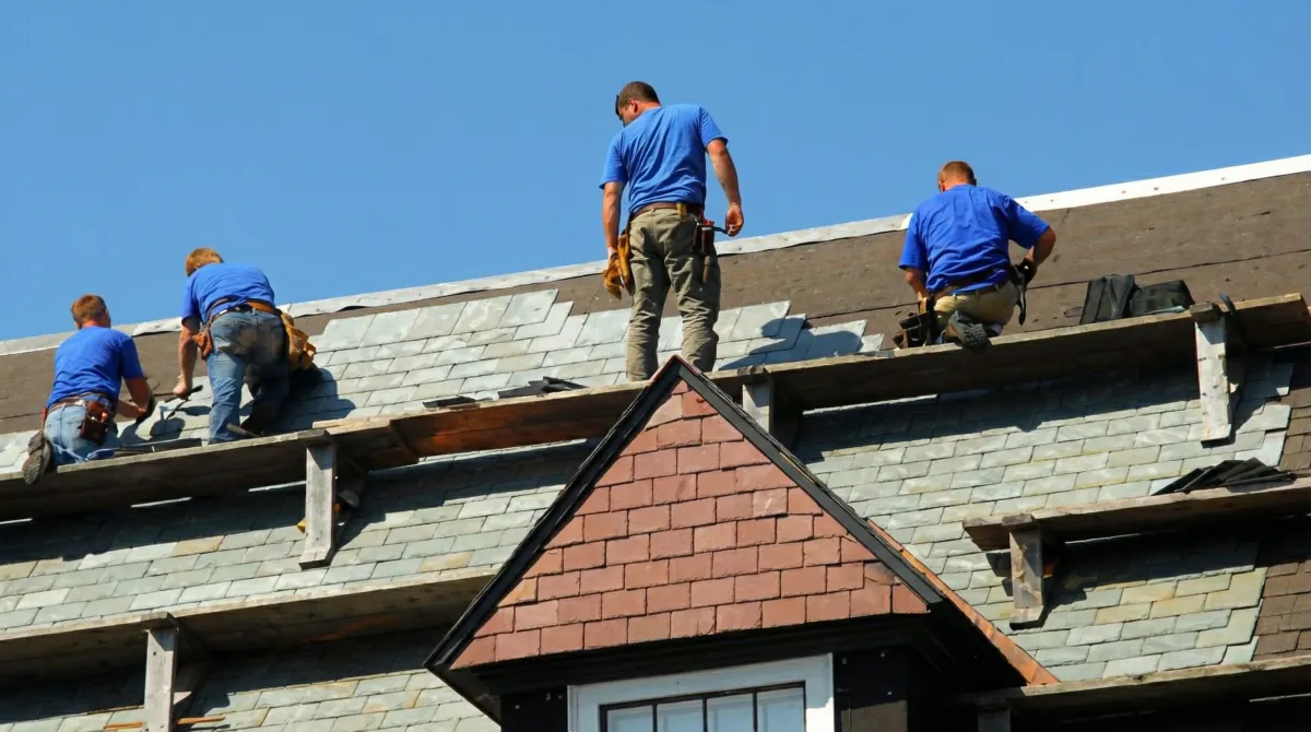 Roof replacement in progress with a team of professional contractors installing new shingles on a residential home in Chandler, AZ